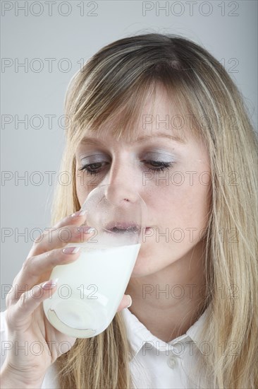 Young woman drinking medicine