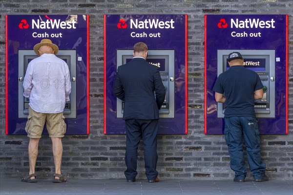 Men at the cash dispenser of NatWest Bank