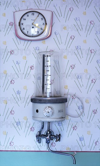 Wall clock and wall water boiler in a 1950s kitchen