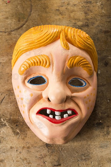 Painted wooden mask on a workbench