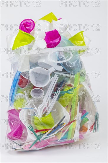 Garbage bag filled with disposable crockery