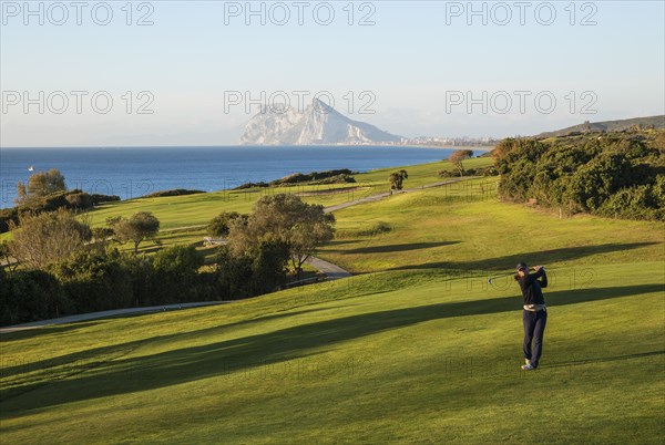 Golfer at La Alcaidesa Golf Resort with Mediterranean Sea and Rock of Gibraltar