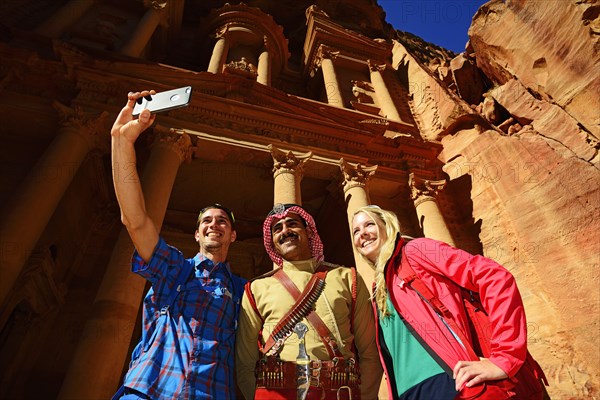 Tourists take a shot with a Bedouin Policeman at Khazne al Firaun