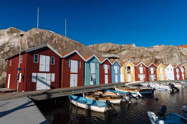 Boats and colourful boathouses in the harbour of Smogen
