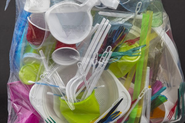 Garbage bag filled with disposable crockery