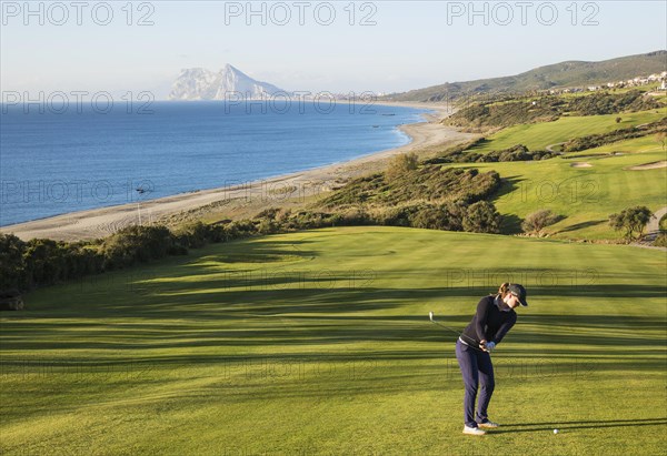 Golfer at La Alcaidesa Golf Resort with Mediterranean Sea and Rock of Gibraltar