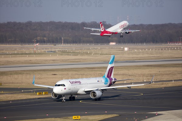 Aircraft euro Wings on Runway and Airberlin taking off