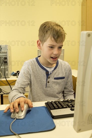 Elementary school student working in computer room