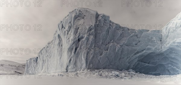 Iceberg in a frozen fjord