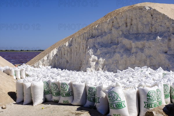 Filled salt sacks next to a salt hill at Lac Rose