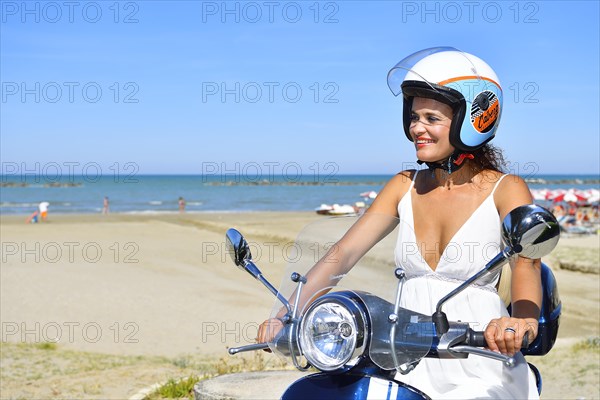 Woman on Vespa scooter