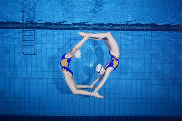 Underwater view of Synchronized Swimming in a swimming pool