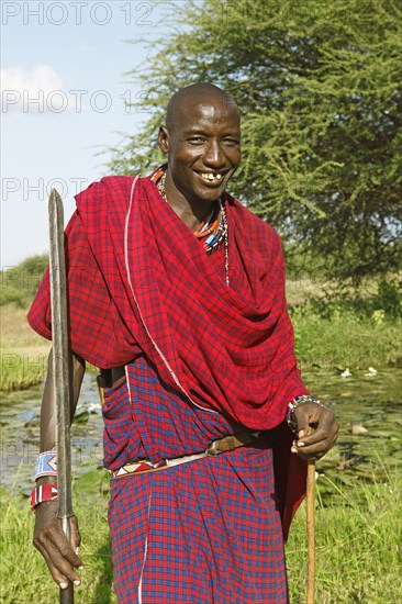 Male Maasai in traditional Shuka clothing with spear