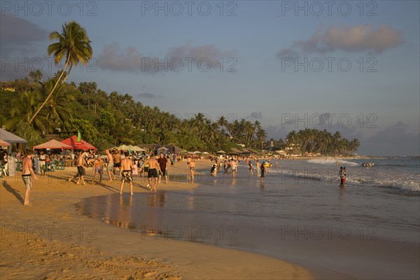 Crowded sandy beach at Mirissa