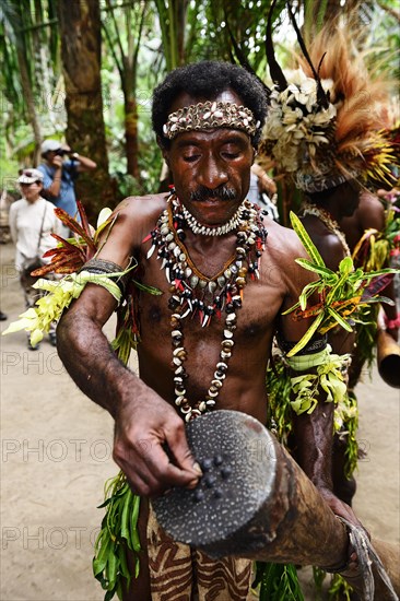 Korafe-Mann tunes his drum with tree resin