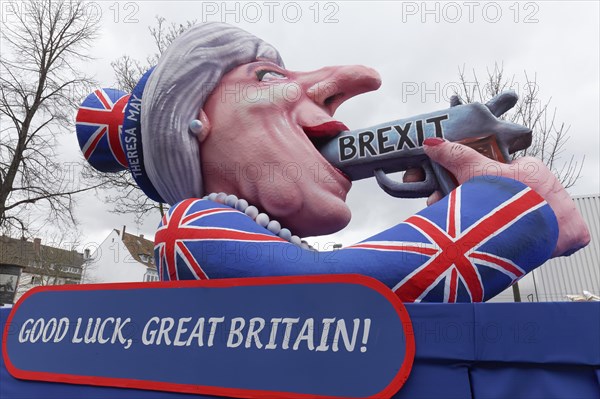 British Prime Minister Theresa May holds gun in her mouth