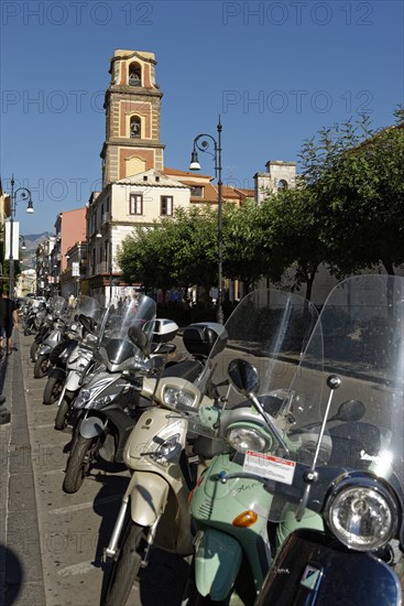 Vespas along the street with cathedral