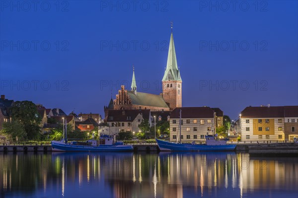 Cityscape at night with St. Olai Church at Oresund in Helsingor