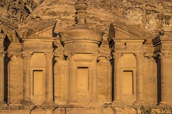 Visitor climbs on the rock temple Monastery Ad Deir