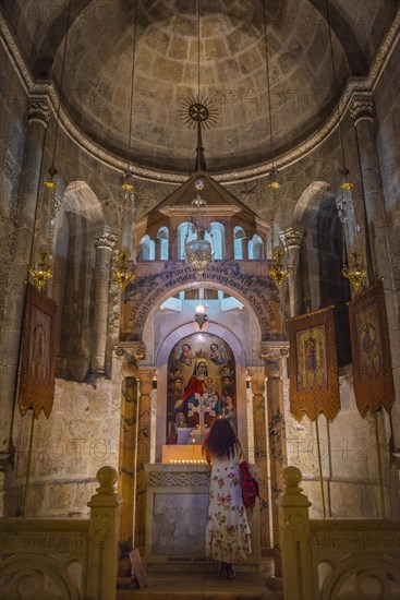 Woman praying in a side chapel of the Tomb Chapel