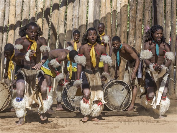 Men in traditional clothing during dance performance