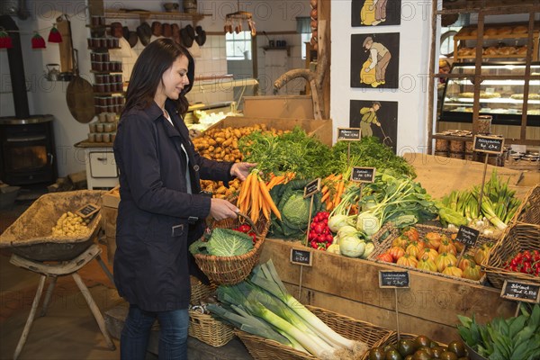 Customer buying carrots at farm shop