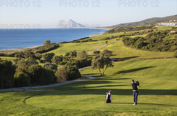 Golfer at La Alcaidesa Golf Resort with Mediterranean Sea and Rock of Gibraltar