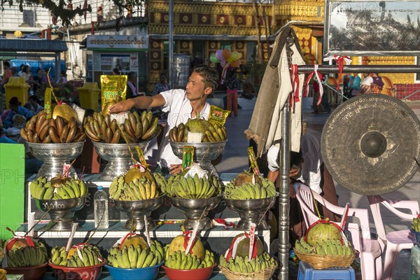 Merchant with offerings in temple complex at Golden Rock Kyaiktiyo Pagoda