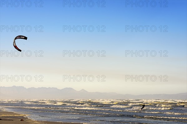 Kitesurfers at high waves