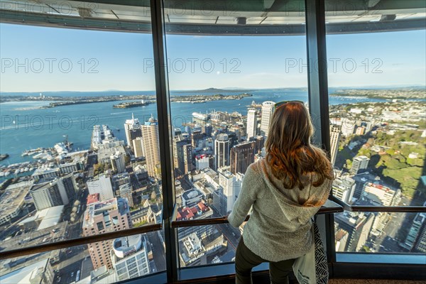 Tourist enjoying the view from the observation deck of the Sky Tower