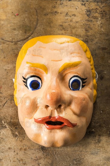 Painted wooden mask on a workbench