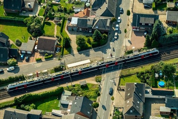 Millingen railway crossing main road with regional train