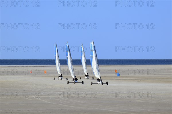 Sand sailors ride on the beach