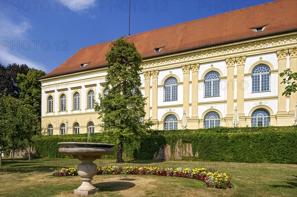 Small fountain in front of castle facade