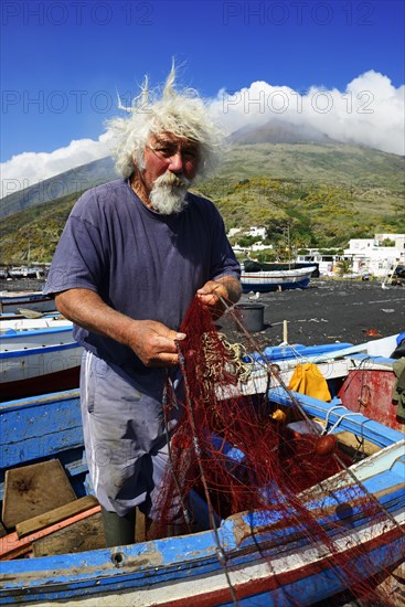 Fishermen repair nets at Scari Beach