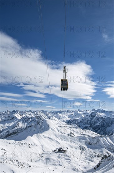 Nebelhorn cable car in front of snow-covered alpine panorama