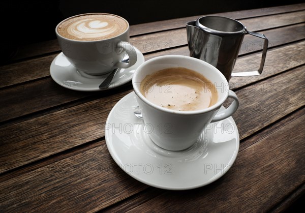 Two cups of coffee on wooden table