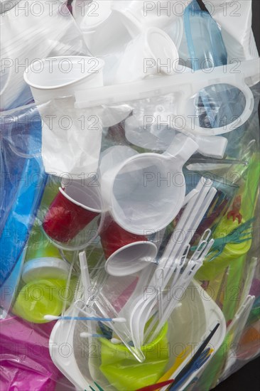 Garbage bag filled with disposable crockery