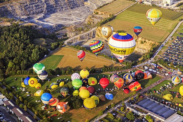 Different colored hot air balloons rising into the air