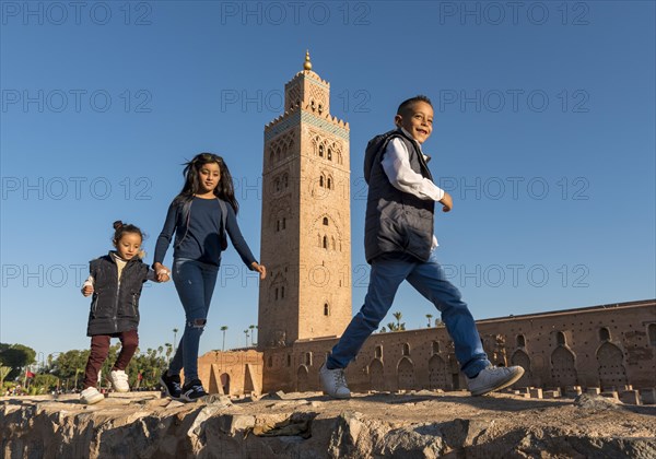 Marrocan children play outside Koutoubia Mosque