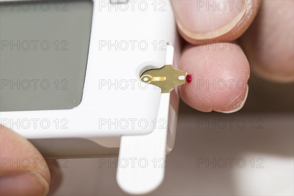 Diabetics measuring blood glucose