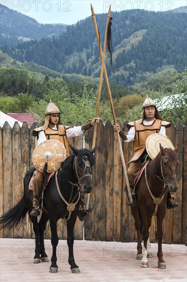 Two men on horseback in front of the entrance to the Kazakh ethnographic village aul Gunny