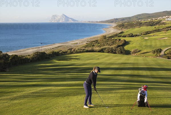 Golfer at La Alcaidesa Golf Resort with Mediterranean Sea and Rock of Gibraltar