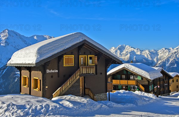 Swiss chalet with a thick layer of snow on the roof with Fletschhorn