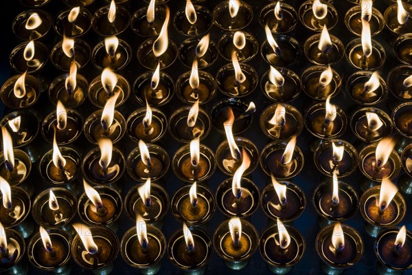 Tibetan butter lamps with burning flames