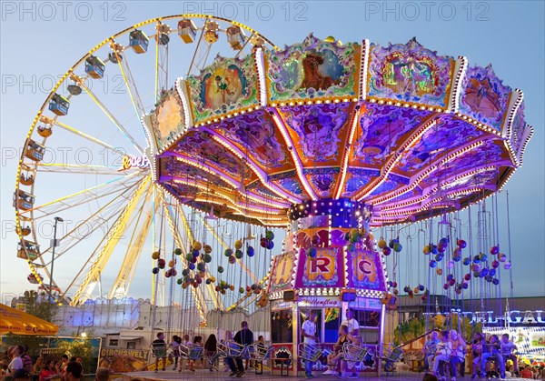 Illuminated swing carousel and Ferris wheel