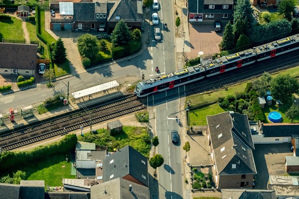 Millingen railway crossing main road with regional train