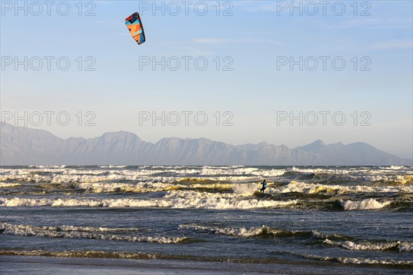 Kitesurfers at high waves