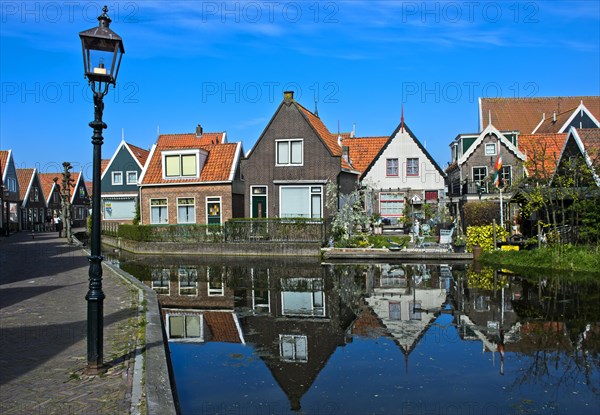 Houses on small channel with water reflection