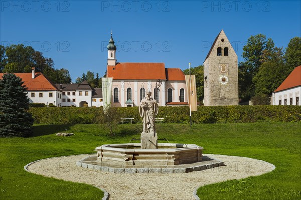 Monastery church with Roman tower and fountain with fountain figure of abbot Walto or Balto